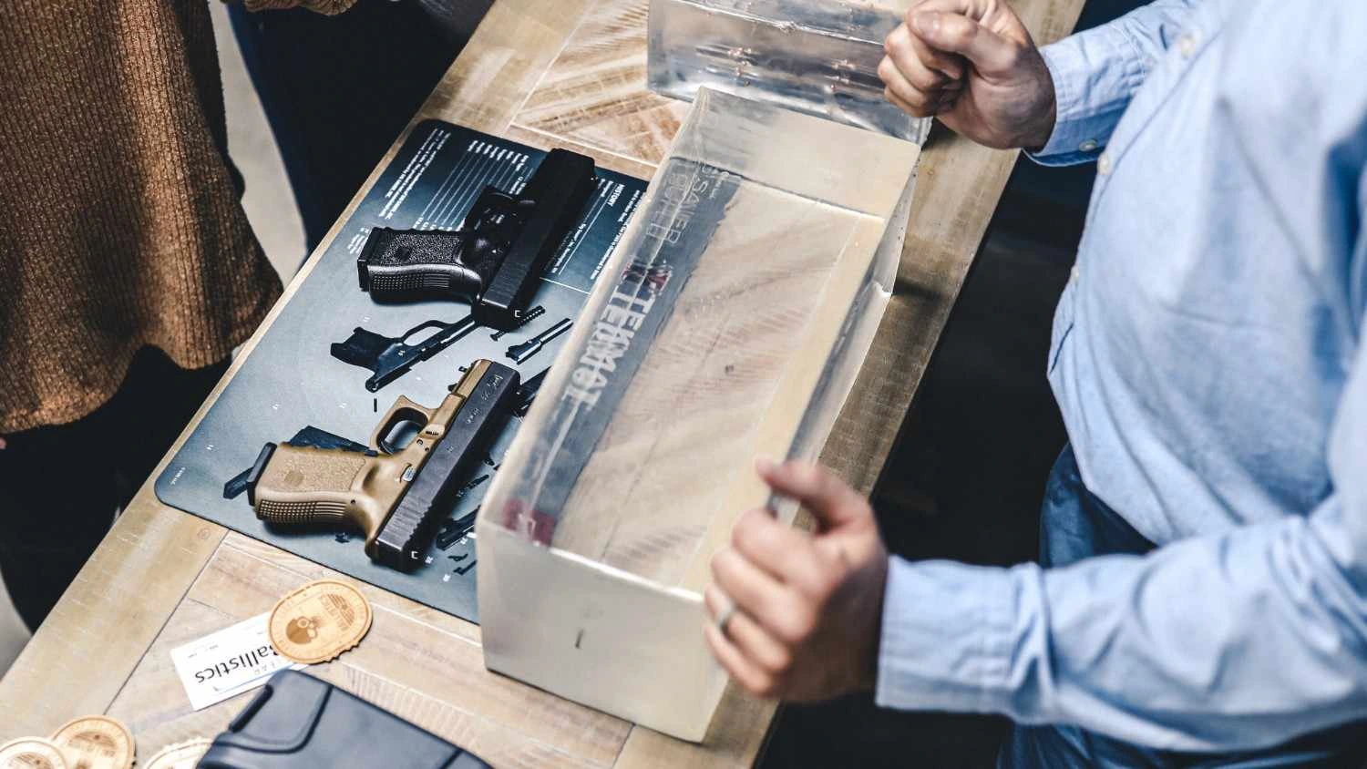 Ballistic gel block testing with handguns on display